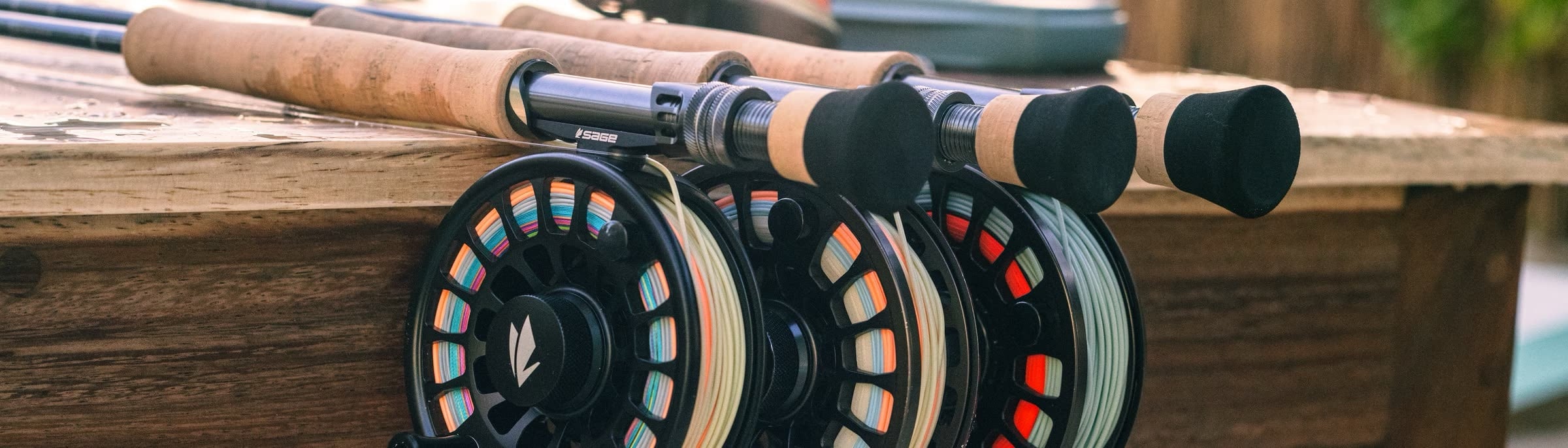 Rigged saltwater outfits laid across a lodge rail