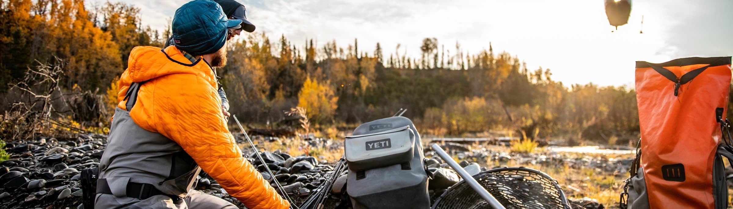A cooler and dry bag on an Alaskan gravel bar