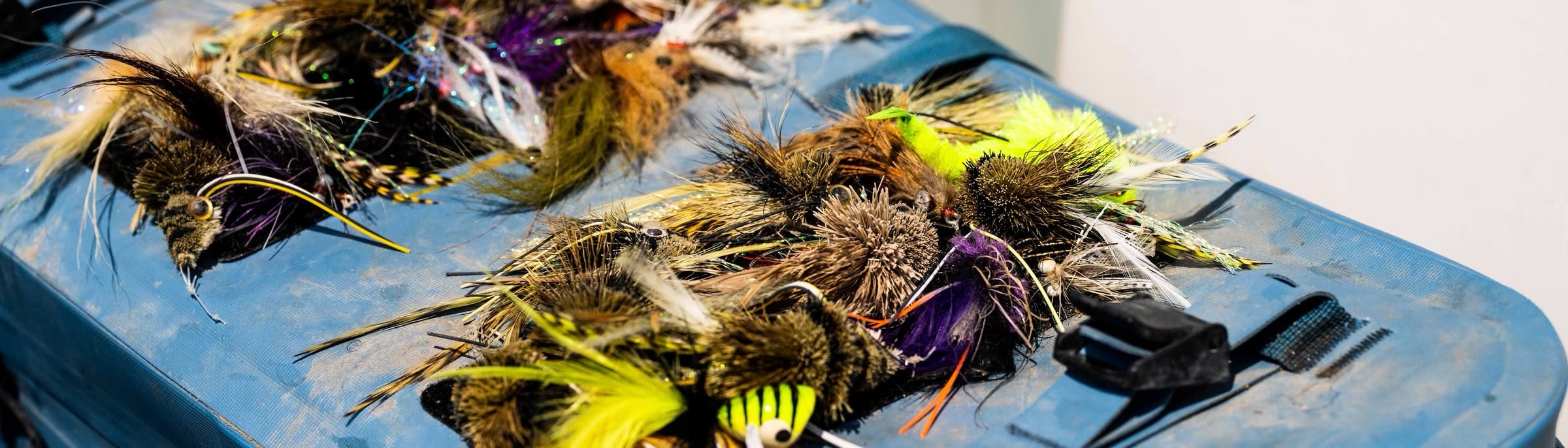 A spread of saltwater flies laid out on a boat