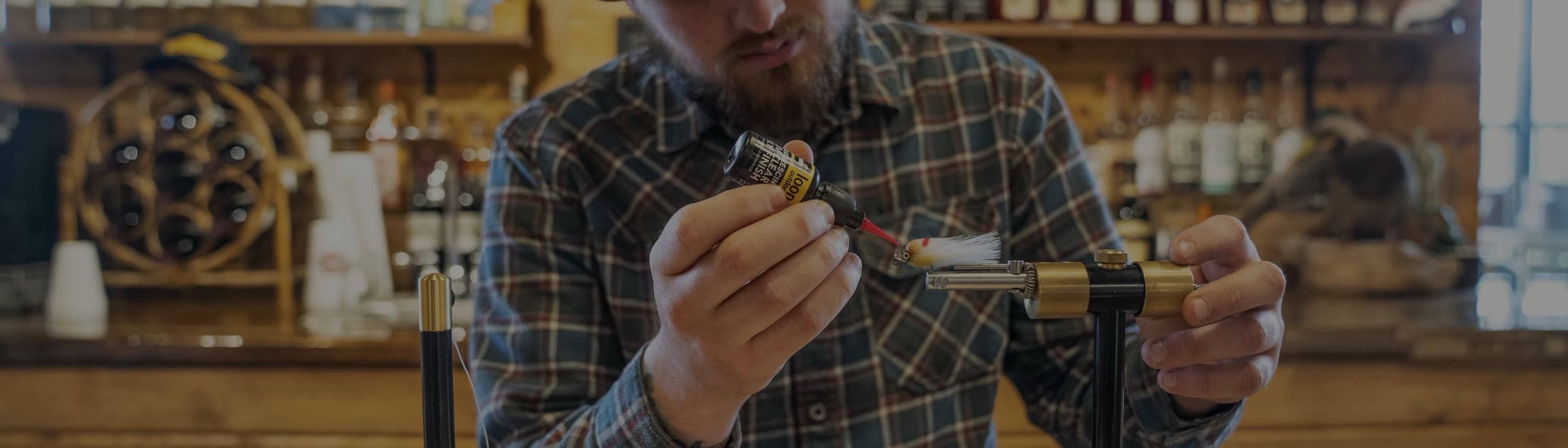 A fly being tied at the vise in the shop