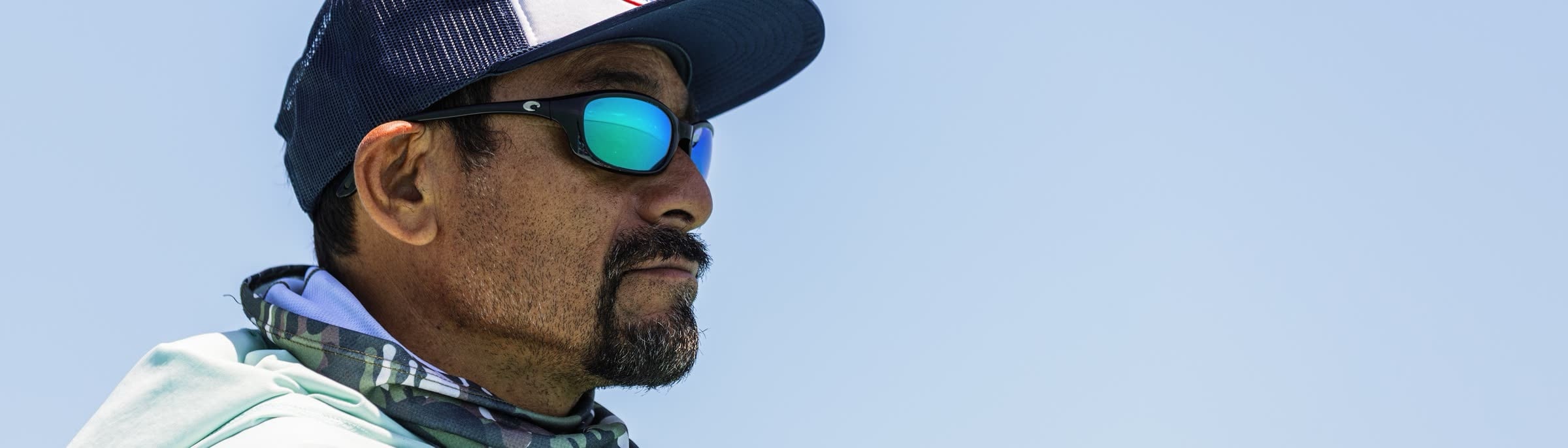 An angler scanning the water in polarised glasses