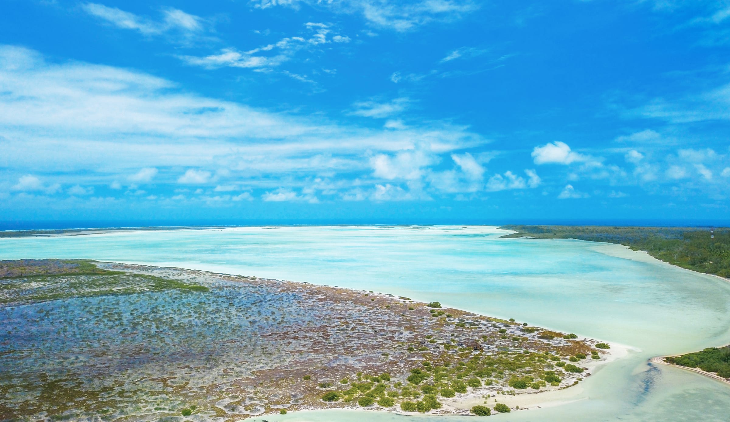 Calm turquoise water over a shallow flat