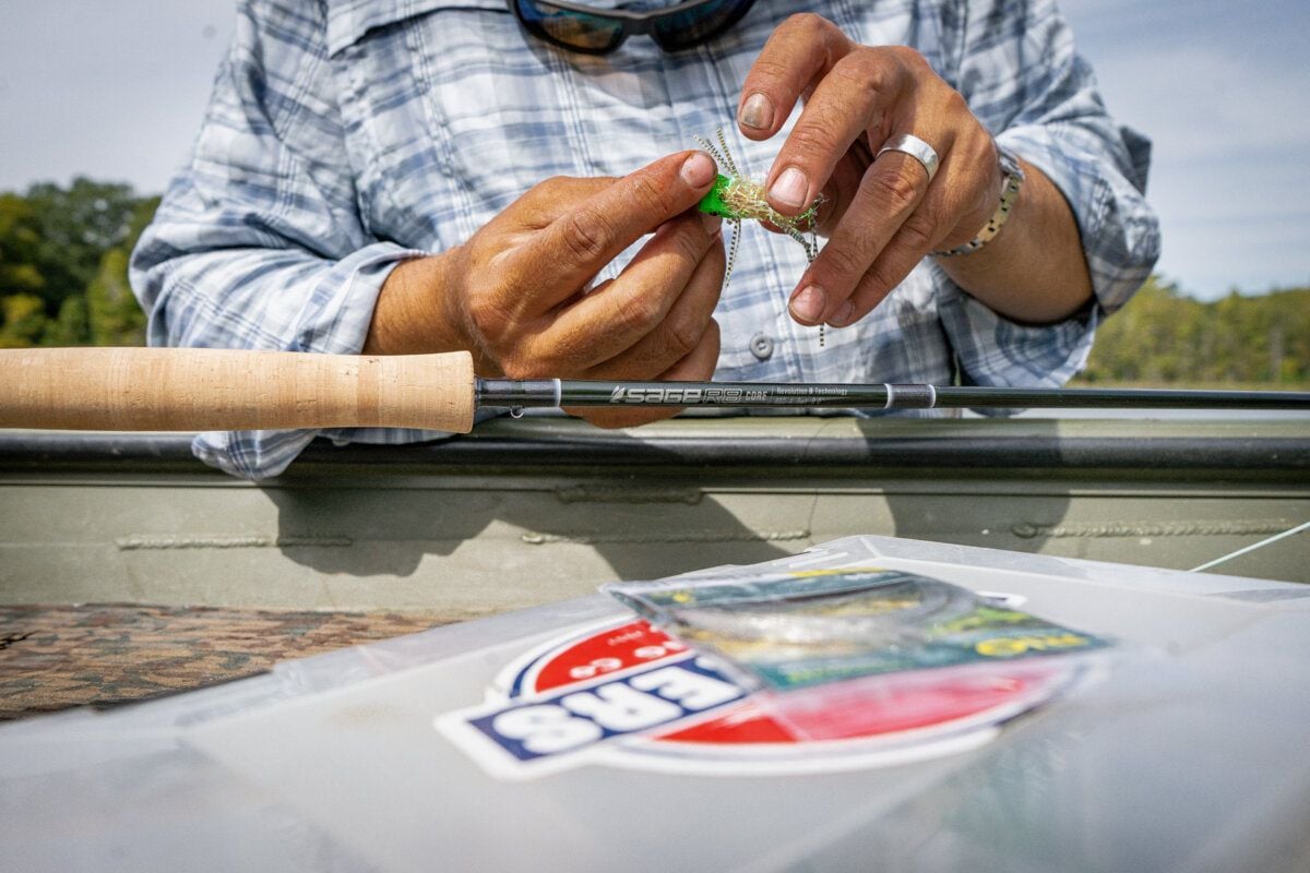 Hands tying a fly at the bench